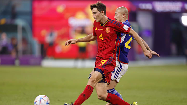 Dec 1, 2022; Doha, Qatar; Spain defender Pau Torres (4) kicks the ball against Japan during the second half of a group stage match during the 2022 World Cup at Khalifa International Stadium. Mandatory Credit: Yukihito Taguchi-Imagn Images