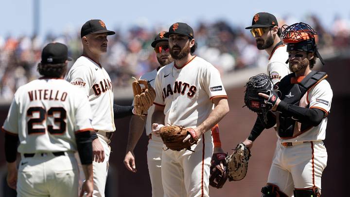 San Francisco, California, USA; San Francisco Giants pitcher Ryan Walker (center) waits to be relieved by manager Tony Vitello (23) during the seventh inning against the Athletics at Oracle Park. Mandatory Credit: D. Ross Cameron-Imagn Images