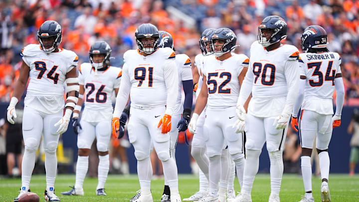 Aug 25, 2024; Denver, Colorado, USA; Members of the Denver Broncos defensive team during the first quarter against the Arizona Cardinals at Empower Field at Mile High. Mandatory Credit: Ron Chenoy-Imagn Images