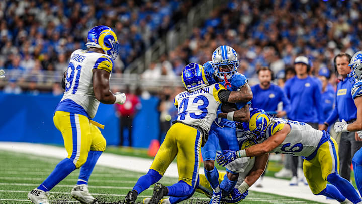 Detroit Lions wide receiver Jameson Williams (9) is tackled by Los Angeles Rams safety John Johnson III (43) and Los Angeles Rams linebacker Christian Rozeboom (56) after making a catch during the first half of the Detroit Lions season opener against the Los Angeles Rams at Ford Field in Detroit, on Sunday, Sept. 8. 2024.