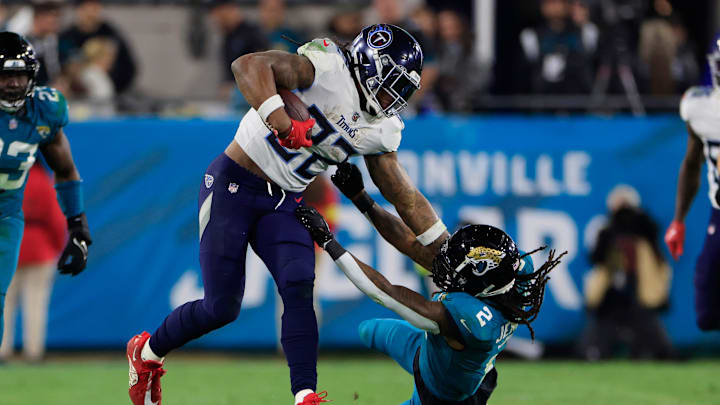 Tennessee Titans running back Derrick Henry (22) stiff arms Jacksonville Jaguars safety Rayshawn Jenkins