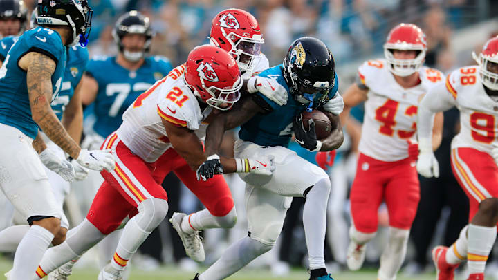Jacksonville Jaguars running back Tank Bigsby (4) rushes for yards against Kansas City Chiefs safety Jaden Hicks (21) and cornerback Joshua Williams (2) during the first quarter of a preseason NFL football game Saturday, Aug. 10, 2024 at EverBank Stadium in Jacksonville, Fla. 