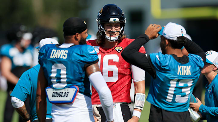 Jacksonville Jaguars quarterback Trevor Lawrence (16) smiles at Jacksonville Jaguars wide receiver Christian Kirk (13) and wide receiver Gabe Davis (0) during a combined NFL football training camp session between the Tampa Bay Buccaneers and Jacksonville Jaguars Wednesday, Aug. 14, 2024 at EverBank Stadium’s Miller Electric Center in Jacksonville, Fla. [Corey Perrine/Florida Times-Union]