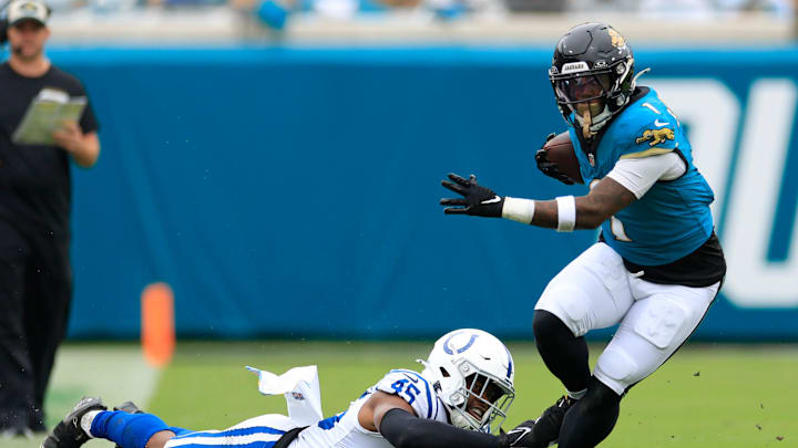 Jacksonville Jaguars running back Travis Etienne Jr. (1) is tripped up by Indianapolis Colts linebacker E.J. Speed (45) during the first quarter of an NFL football matchup Sunday, Oct. 6, 2024 at EverBank Stadium in Jacksonville, Fla. The Jaguars edged the Colts on a field goal 37-34. 