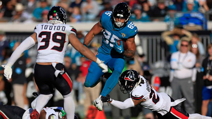 Jacksonville Jaguars tight end Brenton Strange (85) leaps past Houston Texans cornerback Myles Bryant (27) as linebacker Henry To'oTo'o (39) looks on during the third quarter of an NFL football matchup Sunday, Dec. 1, 2024 at EverBank Stadium in Jacksonville, Fla. The Texans held off the Jaguars 23-20. Jacksonville Jaguars tight end Brenton Strange (85) leaps past Houston Texans cornerback Myles Bryant (27) as linebacker Henry To'oTo'o (39) looks on during the third quarter of an NFL football matchup Sunday, Dec. 1, 2024 at EverBank Stadium in Jacksonville, Fla. The Texans held off the Jaguars 23-20.