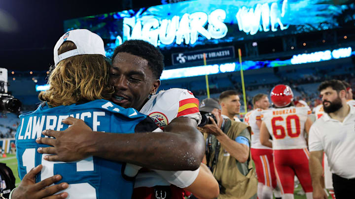 Kansas City Chiefs wide receiver Justyn Ross (8) hugs Jacksonville Jaguars quarterback Trevor Lawrence (16) after the game of a preseason NFL football game Saturday, Aug. 10, 2024 at EverBank Stadium in Jacksonville, Fla. The Jacksonville Jaguars defeated the Kansas City Chiefs 26-13. 