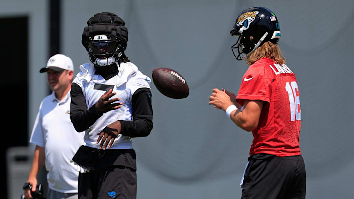 Jacksonville Jaguars wide receiver Brian Thomas Jr. (7), left, tosses the ball to quarterback Trevor Lawrence (16) during an NFL training camp session at the Miller Electric Center, Friday Aug. 15, 2025 in Jacksonville, Fla. [Corey Perrine/Florida Times-Union]