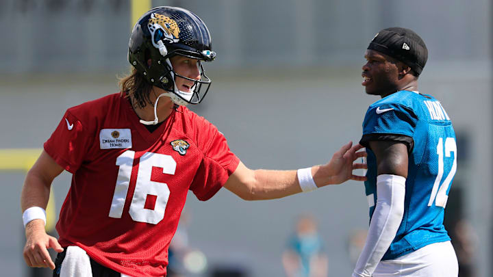 Jacksonville Jaguars quarterback Trevor Lawrence (16) talks technique with wide receiver Travis Hunter (12) after an NFL training camp session at the Miller Electric Center, Sunday, Aug. 3, 2025, in Jacksonville, Fla. [Corey Perrine/Florida Times-Union]