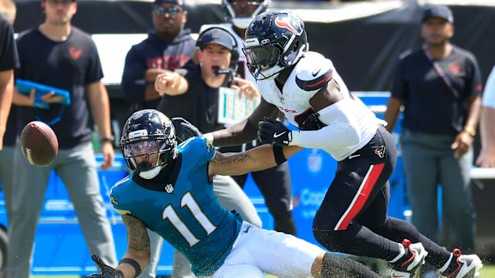 Jacksonville Jaguars wide receiver Parker Washington (11) can’t haul in a reception against Houston Texans linebacker Christian Harris (48) during the second quarter of an NFL football matchup at EverBank Stadium, Sunday, Sept. 21, 2025, in Jacksonville, Fla. The Jaguars defeated the Texans 17-10. 