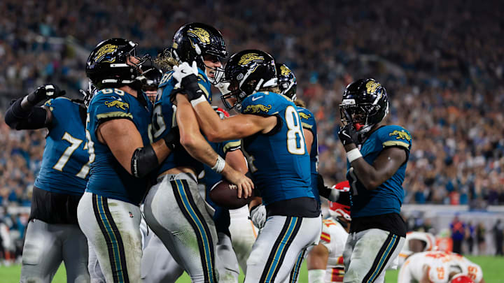 Jacksonville Jaguars quarterback Trevor Lawrence (16) is celebrated by offensive tackle Patrick Mekari (65) and tight end Hunter Long (84) for his touchdown score with other teammates joining in for his game-winning touchdown during the fourth quarter of an NFL football matchup at EverBank Stadium, Monday, Oct. 6, 2025, in Jacksonville, Fla