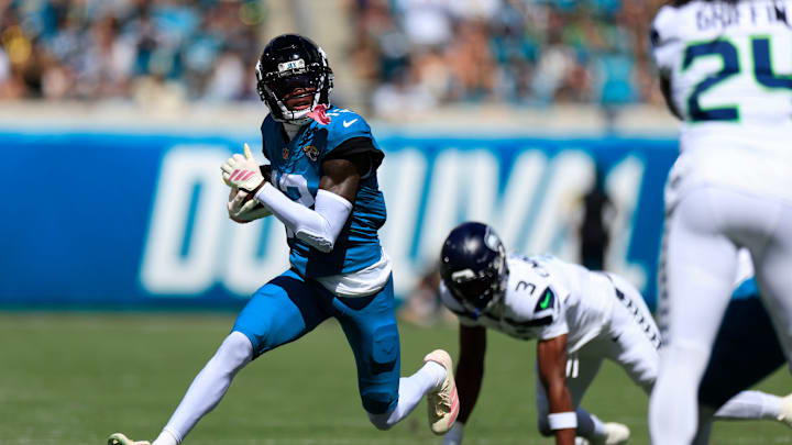 Jacksonville Jaguars wide receiver Travis Hunter (12) rushes for yards against Seattle Seahawks safety Nick Emmanwori (3) during the first quarter of an NFL football matchup, Sunday, Oct. 12, 2025, at EverBank Stadium in Jacksonville, Fla. Jacksonville Jaguars wide receiver Travis Hunter (12) rushes for yards against Seattle Seahawks safety Nick Emmanwori (3) during the first quarter of an NFL football matchup, Sunday, Oct. 12, 2025, at EverBank Stadium in Jacksonville, Fla.