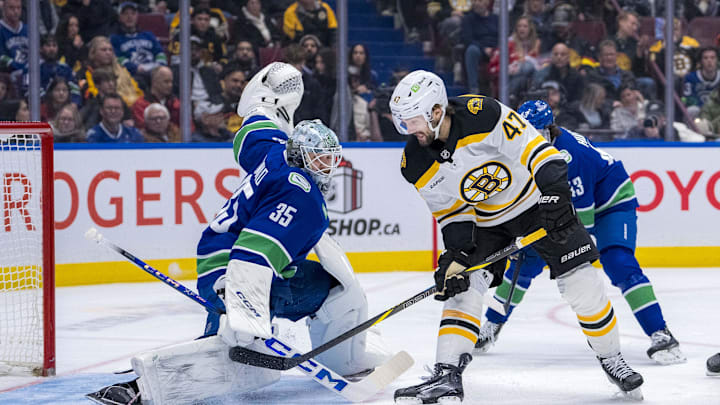 Dec 14, 2024; Vancouver, British Columbia, CAN;  Vancouver Canucks defenseman Quinn Hughes (43) watches as goalie Thatcher Demko (35) makes a save on Boston Bruins forward Mark Kastelic (47) during the first period at Rogers Arena. Mandatory Credit: Bob Frid-Imagn Images
