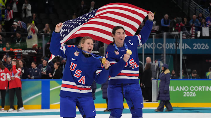 Feb 19, 2026; Milan, Italy; Kendall Coyne (26) of the United States and Hilary Knight (21) of the United States celebrate after winning the gold medal in women's ice hockey after defeating Canada during the Milano Cortina 2026 Olympic Winter Games at Milano Santagiulia Ice Hockey Arena. Mandatory Credit: Amber Searls-Imagn Images