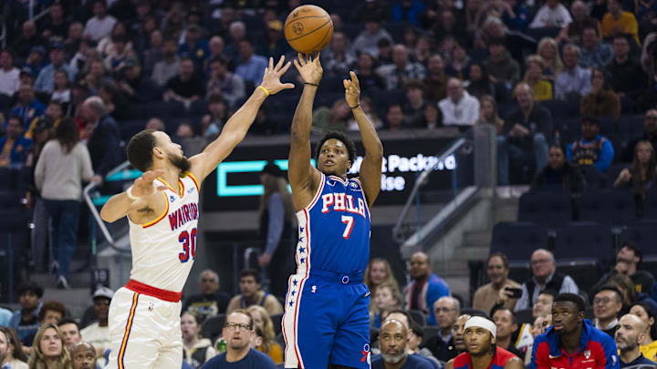 Jan 2, 2025; San Francisco, California, USA; Philadelphia 76ers guard Kyle Lowry (7) takes a three-point shot over Golden State Warriors guard Stephen Curry (30) during the first quarter at Chase Center. Mandatory Credit: John Hefti-Imagn Images