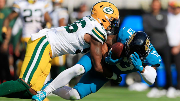 Green Bay Packers linebacker Edgerrin Cooper (56) tackles Jacksonville Jaguars wide receiver Christian Kirk (13) during the fourth quarter of an NFL football matchup Sunday, Oct. 27, 2024 at EverBank Stadium in Jacksonville, Fla. The Packers edged the Jaguars 30-27 on a last-second field goal. [Corey Perrine/Florida Times-Union]