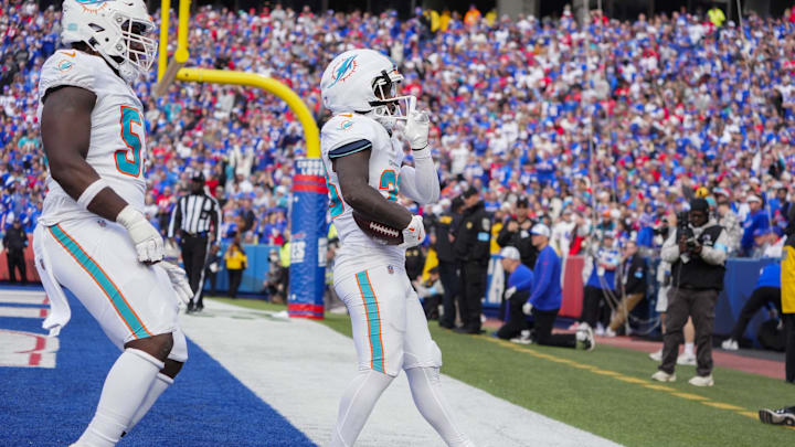 Nov 3, 2024; Orchard Park, New York, USA; Miami Dolphins running back De'Von Achane (28) reacts to scoring a touchdown against the Buffalo Bills during the second half at Highmark Stadium. Mandatory Credit: Gregory Fisher-Imagn Images
