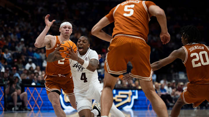 Texas Longhorns guard Chendall Weaver (2) guards Texas A&M Aggies guard Wade Taylor IV (4) during their second round game of the SEC Men's Basketball Tournament at Bridgestone Arena in Nashville, Tenn., Thursday, March 13, 2025.