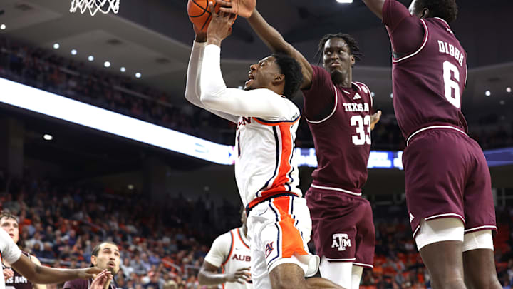Auburn Tigers guard Kevin Overton (1) goes up for a shot as Texas A&M Aggies center Federiko Federiko (33) and guard Ali Dibba (6) defend during the second half at Neville Arena. Mandatory Credit: John Reed-Imagn Images