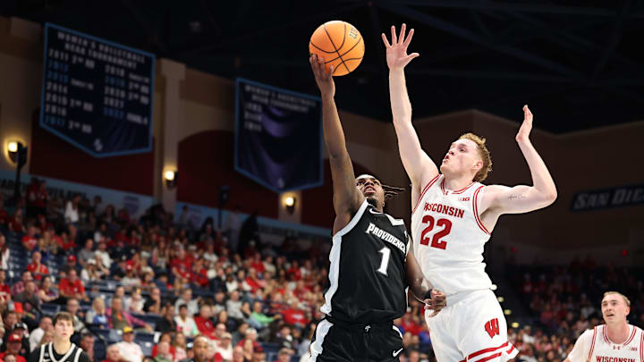 Nov 27, 2025; San Diego, CA, USA; Providence Friars guard Jason Edwards (1) shoots the ball against Wisconsin Badgers forward Austin Rapp (22) during the first half at Jenny Craig Pavilion. Nov 27, 2025; San Diego, CA, USA; Providence Friars guard Jason Edwards (1) shoots the ball against Wisconsin Badgers forward Austin Rapp (22) during the first half at Jenny Craig Pavilion.