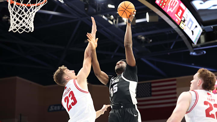 Nov 27, 2025; San Diego, CA, USA; Providence Friars forward Oswin Erhunmwunse (55) shoots the ball against Wisconsin Badgers forward Will Garlock (23) during the first half at Jenny Craig Pavilion. 