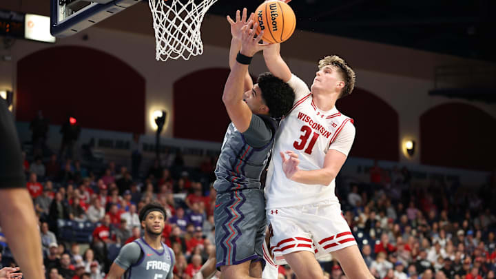 Nov 28, 2025; San Diego, CA, USA; Wisconsin Badgers forward Nolan Winter (31) blocks Texas Christian University Horned Frogs forward David Punch (15) during the second half at Jenny Craig Pavilion. 