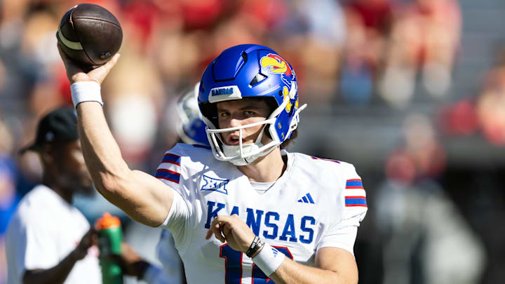 Kansas Jayhawks quarterback David McComb (16) has ties to the Wisconsin Badgers in the transfer portal. Kansas Jayhawks quarterback David McComb (16) has ties to the Wisconsin Badgers in the transfer portal.