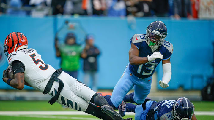 Cincinnati Bengals wide receiver Tee Higgins (5) catches a touchdown pass as Tennessee Titans cornerback Chidobe Awuzie (13) looks on during the second quarter at Nissan Stadium in Nashville, Tenn., Sunday, Dec. 15, 2024.