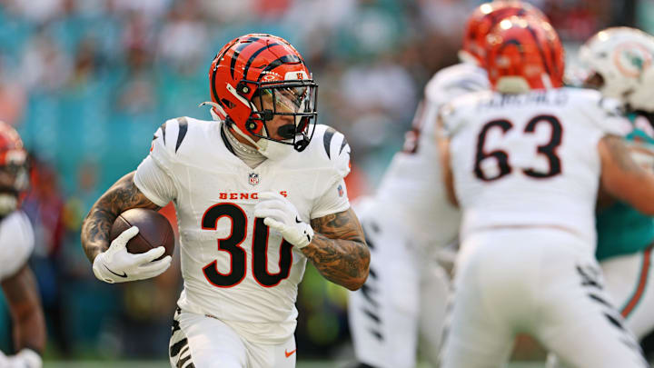 Dec 21, 2025; Miami Gardens, Florida, USA; Cincinnati Bengals quarterback Joe Burrow (9) hands off the ball to Cincinnati Bengals running back Chase Brown (30) during the first quarter at Hard Rock Stadium. Mandatory Credit: Nathan Ray Seebeck-Imagn Images