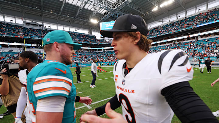 Dec 21, 2025; Miami Gardens, Florida, USA; Miami Dolphins quarterback Quinn Ewers (14) and Cincinnati Bengals quarterback Joe Burrow (9) react after the game at Hard Rock Stadium. Mandatory Credit: Nathan Ray Seebeck-Imagn Images