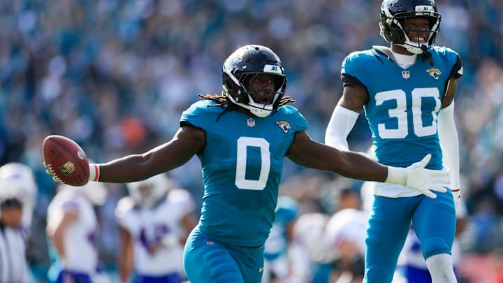 Jacksonville Jaguars linebacker Devin Lloyd (0) celebrates a fumble recovery with cornerback Montaric Brown (30) during the second quarter of an NFL football AFC Wild Card playoff matchup, Sunday, Jan. 11, 2026, in Jacksonville, Fla. [Corey Perrine/Florida Times-Union]