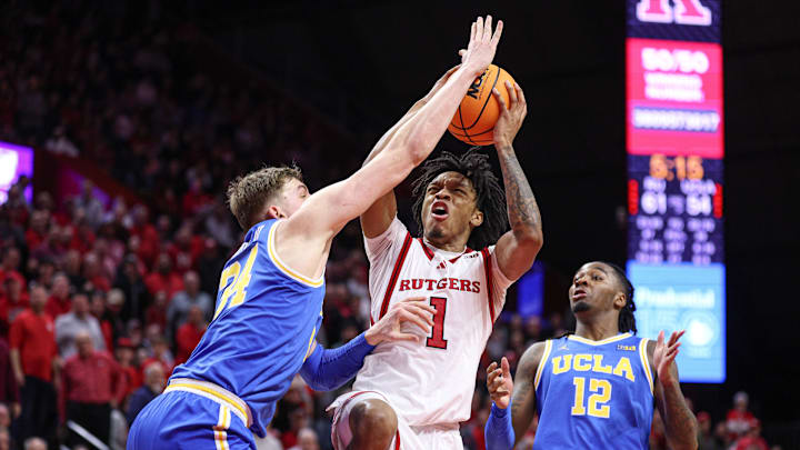 Jan 13, 2025; Piscataway, New Jersey, USA; Rutgers Scarlet Knights guard Jamichael Davis (1) shoots the ball as UCLA Bruins forward Tyler Bilodeau (34) and guard Sebastian Mack (12) during the second half at Jersey Mike's Arena. Mandatory Credit: Vincent Carchietta-Imagn Images