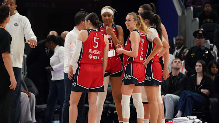 May 21, 2025; San Francisco, California, USA;  Washington Mystics guard Jade Melbourne (5), forward Kiki Iriafen (44), guard Lucy Olsen (33) and the team huddle during a timeout against the Golden State Valkyries at Chase Center. Mandatory Credit: David Gonzales-Imagn Images