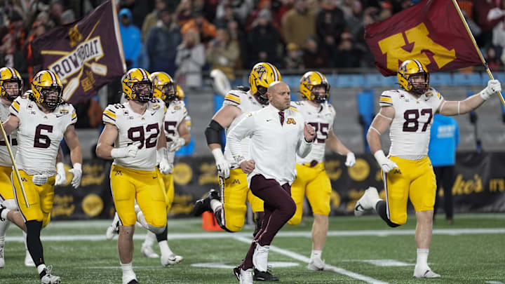 Jan 3, 2025; Charlotte, NC, USA; Minnesota Golden Gophers head coach P.J. Fleck leads his team onto the field during the first quarter against the Virginia Tech Hokies at the Dukes’ Mayo Bowl at Bank of America Stadium. Mandatory Credit: Jim Dedmon-Imagn Images Jan 3, 2025; Charlotte, NC, USA; Minnesota Golden Gophers head coach P.J. Fleck leads his team onto the field during the first quarter against the Virginia Tech Hokies at the Dukes’ Mayo Bowl at Bank of America Stadium. Mandatory Credit: Jim Dedmon-Imagn Images