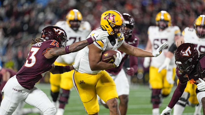 Jan 3, 2025; Charlotte, NC, USA; Minnesota Golden Gophers running back Jaren Mangham (8) runs for yardage chased by Virginia Tech Hokies cornerback Thomas Williams (23) during the second quarter at the Duke’s Mayo Bowl at Bank of America Stadium. Mandatory Credit: Jim Dedmon-Imagn Images Jan 3, 2025; Charlotte, NC, USA; Minnesota Golden Gophers running back Jaren Mangham (8) runs for yardage chased by Virginia Tech Hokies cornerback Thomas Williams (23) during the second quarter at the Duke’s Mayo Bowl at Bank of America Stadium. Mandatory Credit: Jim Dedmon-Imagn Images