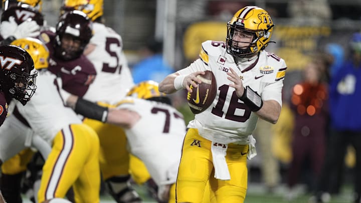 Jan 3, 2025; Charlotte, NC, USA; Minnesota Golden Gophers quarterback Max Brosmer (16)  looks for a receiver during the first quarter against the Virginia Tech Hokies at the Dukes’ Mayo Bowl at Bank of America Stadium. Mandatory Credit: Jim Dedmon-Imagn Images