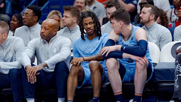 Dec 27, 2024; New Orleans, Louisiana, USA; Memphis Grizzlies guard Ja Morant, center, wears flip flops after returning from a screen collision during the second half against the New Orleans Pelicans at Smoothie King Center. Morant did not play after the third quarter. 