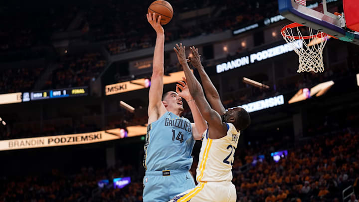 Apr 15, 2025; San Francisco, California, USA; Memphis Grizzlies center Zach Edey (14) shoots over Golden State Warriors forward Draymond Green (23) in the second quarter at the Chase Center. Mandatory Credit: Cary Edmondson-Imagn Images