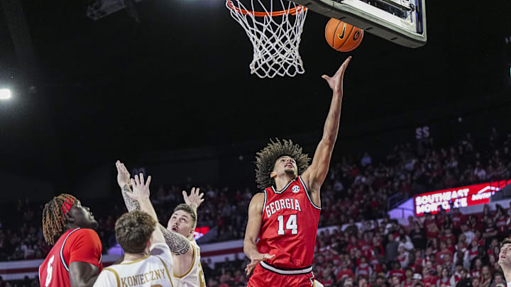 Dec 3, 2024; Athens, Georgia, USA; Georgia Bulldogs forward Asa Newell (14) scores a basket past Notre Dame Fighting Irish forward Nikita Konstantynovskyi (25) during the first half at Stegeman Coliseum. Mandatory Credit: Dale Zanine-Imagn Images