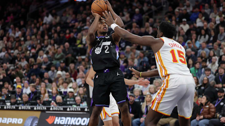 Jan 7, 2025; Salt Lake City, Utah, USA;  Utah Jazz guard Collin Sexton (2) shoots the ball over Atlanta Hawks center Clint Capela (15) during the second half at Delta Center. Mandatory Credit: Chris Nicoll-Imagn Images