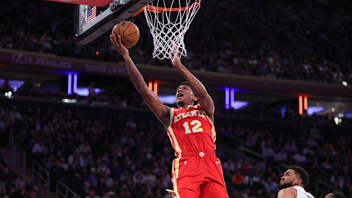 Jan 20, 2025; New York, New York, USA; Atlanta Hawks forward De'Andre Hunter (12) goes up for a basket in front of New York Knicks center Karl-Anthony Towns (32) during the second half at Madison Square Garden. Mandatory Credit: Vincent Carchietta-Imagn Images