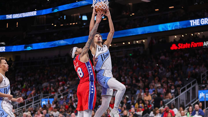 Mar 23, 2025; Atlanta, Georgia, USA; Atlanta Hawks forward Zaccharie Risacher (10) shoots past Philadelphia 76ers forward Chuma Okeke (18) in the third quarter at State Farm Arena. Mandatory Credit: Brett Davis-Imagn Images Mar 23, 2025; Atlanta, Georgia, USA; Atlanta Hawks forward Zaccharie Risacher (10) shoots past Philadelphia 76ers forward Chuma Okeke (18) in the third quarter at State Farm Arena. Mandatory Credit: Brett Davis-Imagn Images