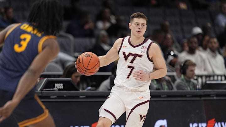Mar 11, 2025; Charlotte, NC, USA; Virginia Tech Hokies guard Brandon Rechsteiner (7) brings the ball up court against the California Golden Bears during the OT at Spectrum Center. Mandatory Credit: Jim Dedmon-Imagn Images