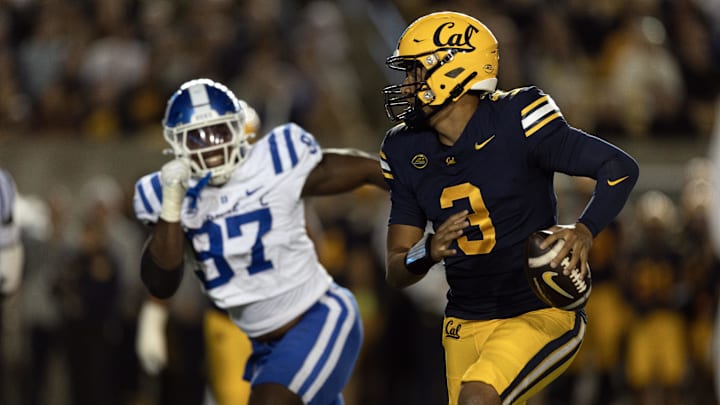 Oct 4, 2025; Berkeley, California, USA; California Golden Bears quarterback Jaron-Keawe Sagapolutele (3) scrambles away from pressure by Duke Blue Devils defensive end Wesley Williams (97) during the second quarter at California Memorial Stadium. Mandatory Credit: D. Ross Cameron-Imagn Images