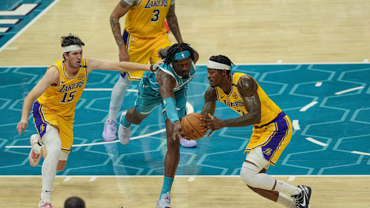 Jan 27, 2025; Charlotte, North Carolina, USA; Charlotte Hornets center Mark Williams (5) tries for a steal from Los Angeles Lakers forward Jarred Vanderbilt (2) during the second half at the Spectrum Center. Mandatory Credit: Jim Dedmon-Imagn Images