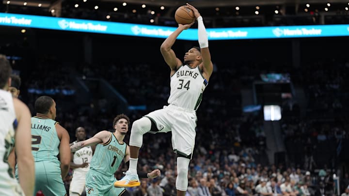 Nov 16, 2024; Charlotte, North Carolina, USA; Milwaukee Bucks forward Giannis Antetokounmpo (34) shoots a jumper against Charlotte Hornets guard LaMelo Ball (1) during the second quarter at Spectrum Center. Mandatory Credit: Jim Dedmon-Imagn Images