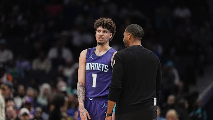 Mar 20, 2025; Charlotte, North Carolina, USA; Charlotte Hornets guard LaMelo Ball (1) talks with head coach Charles Lee  during a  free throw during the second half against the New York Knicks at Spectrum Center. Mandatory Credit: Jim Dedmon-Imagn Images