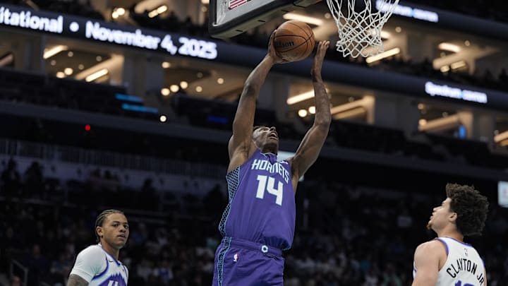 Nov 2, 2025; Charlotte, North Carolina, USA; Charlotte Hornets forward Moussa Diabate (14) makes a lay up against the Utah Jazz during the second quarter at Spectrum Center. Mandatory Credit: Jim Dedmon-Imagn Images