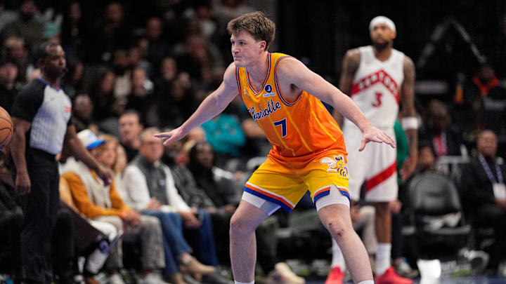 Nov 29, 2025; Charlotte, North Carolina, USA; Charlotte Hornets guard Kon Knueppel (7) defends against against the Toronto Raptors during the second quarter at Spectrum Center. Mandatory Credit: Jim Dedmon-Imagn Images