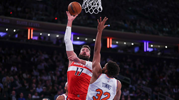 Oct 9, 2024; New York, New York, USA; Washington Wizards center Jonas Valanciunas (17) shoots the ball as New York Knicks center Karl-Anthony Towns (32) defends during the first quarter at Madison Square Garden. Mandatory Credit: Vincent Carchietta-Imagn Images