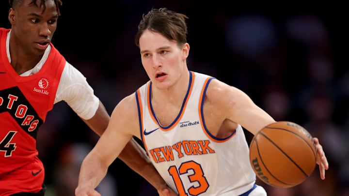 Dec 23, 2024; New York, New York, USA; New York Knicks guard Tyler Kolek (13) controls the ball against Toronto Raptors guard Ja'Kobe Walter (14) during the fourth quarter at Madison Square Garden. Mandatory Credit: Brad Penner-Imagn Images